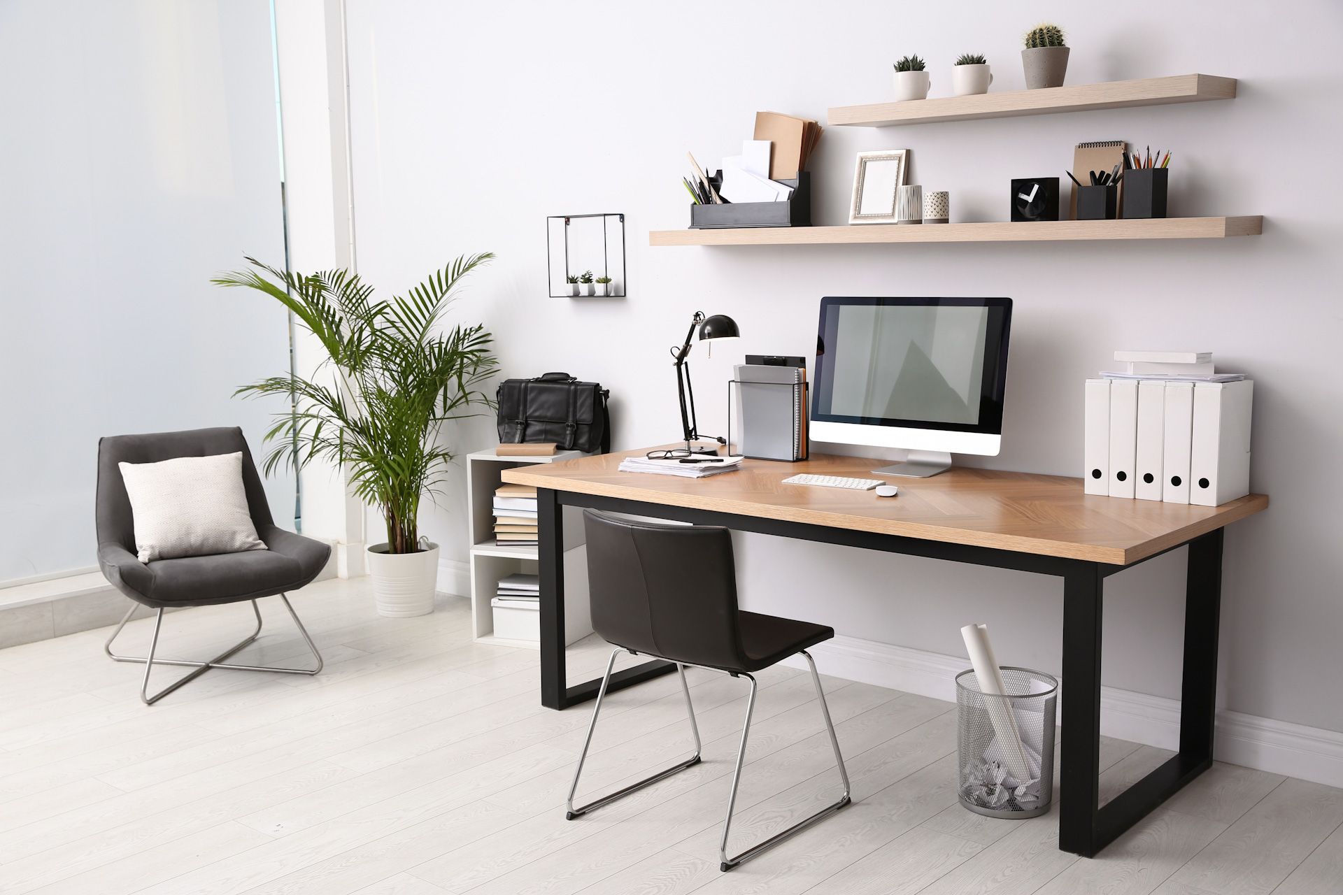 A desk with a computer on it in the room