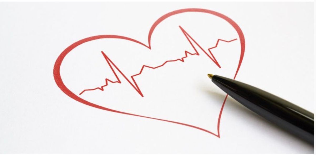A pen is pointing at a heart with a heartbeat line drawn on it.