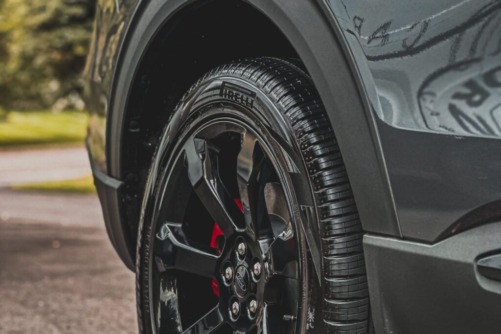 A close up of a car tire on a road.
