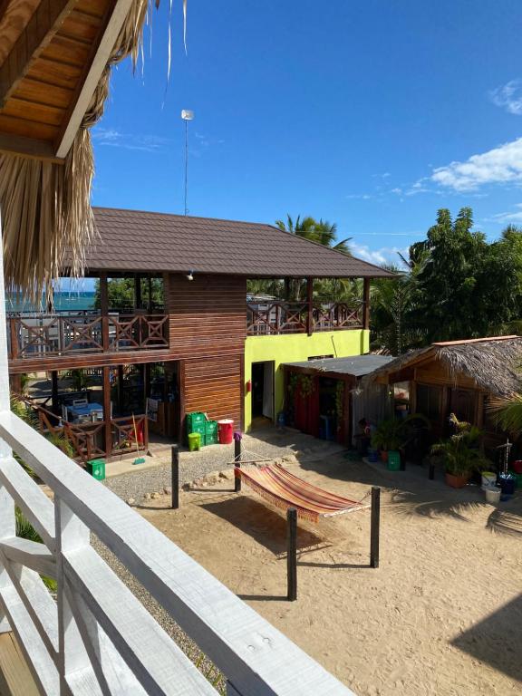 A view of a house from a balcony with a hammock in front of it