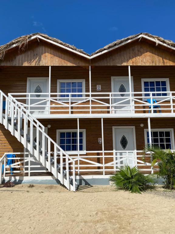 A wooden house with stairs leading up to the second floor