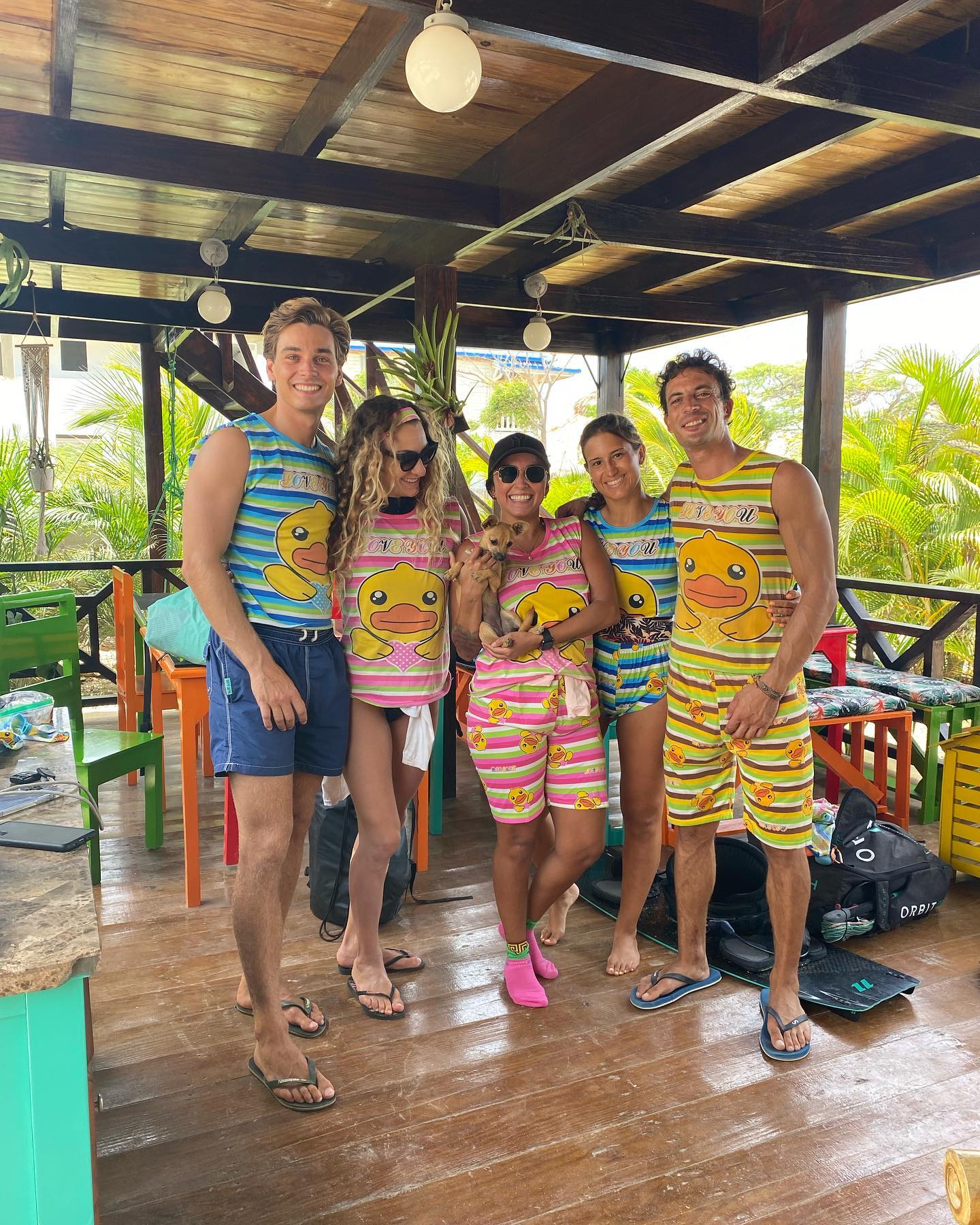 A group of people are posing for a picture on a wooden deck.
