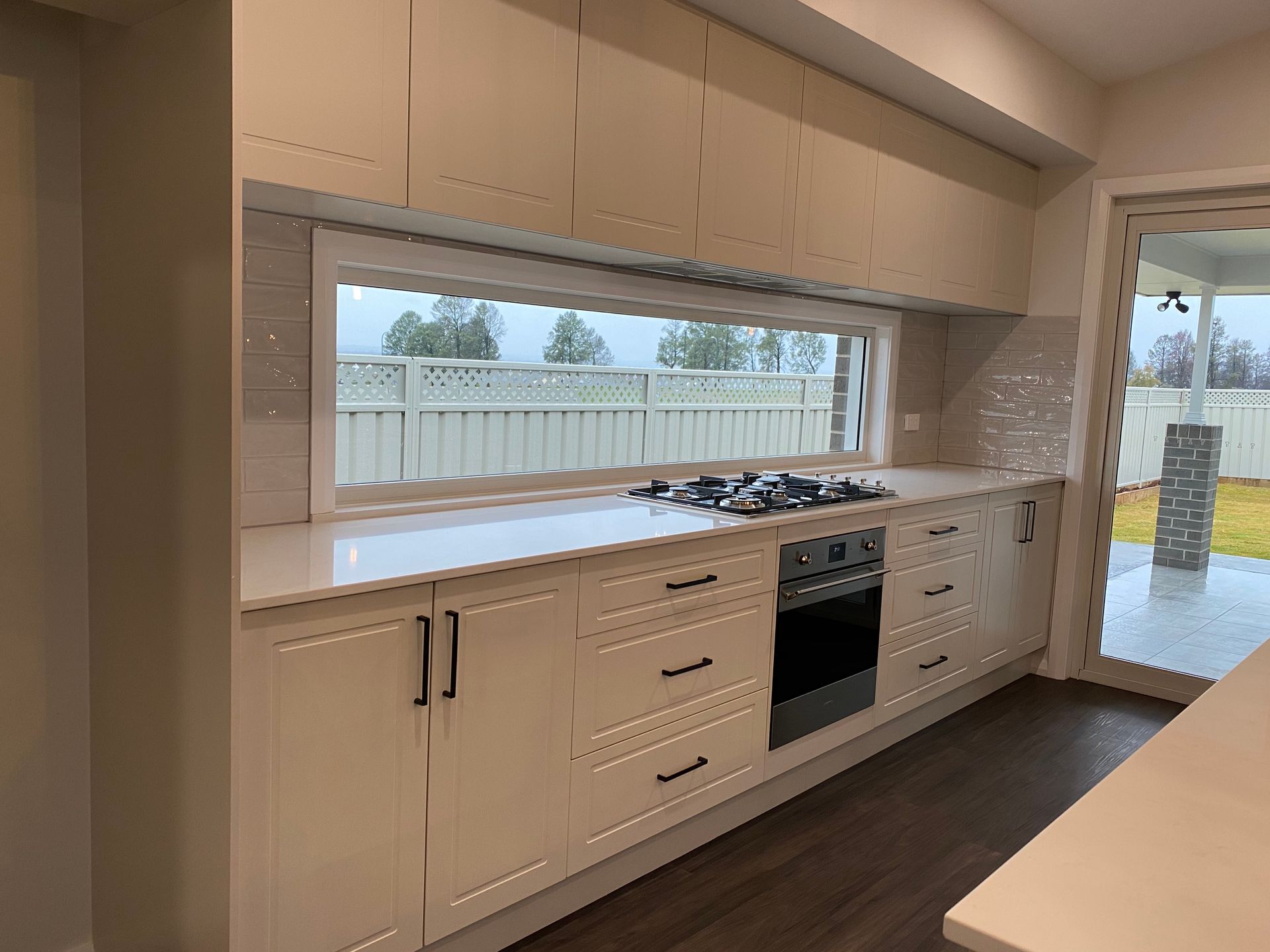 Countertop and Stove With White Cabintes — Kitchen Renovations in Dubbo, QLD