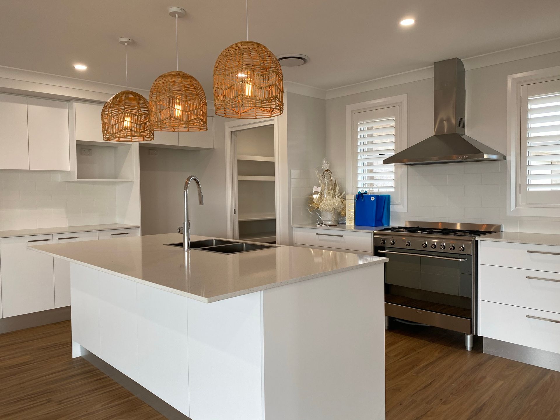 A Kitchen Sink Shot With White Marble Countertop — Kitchen Renovations in Dubbo, QLD