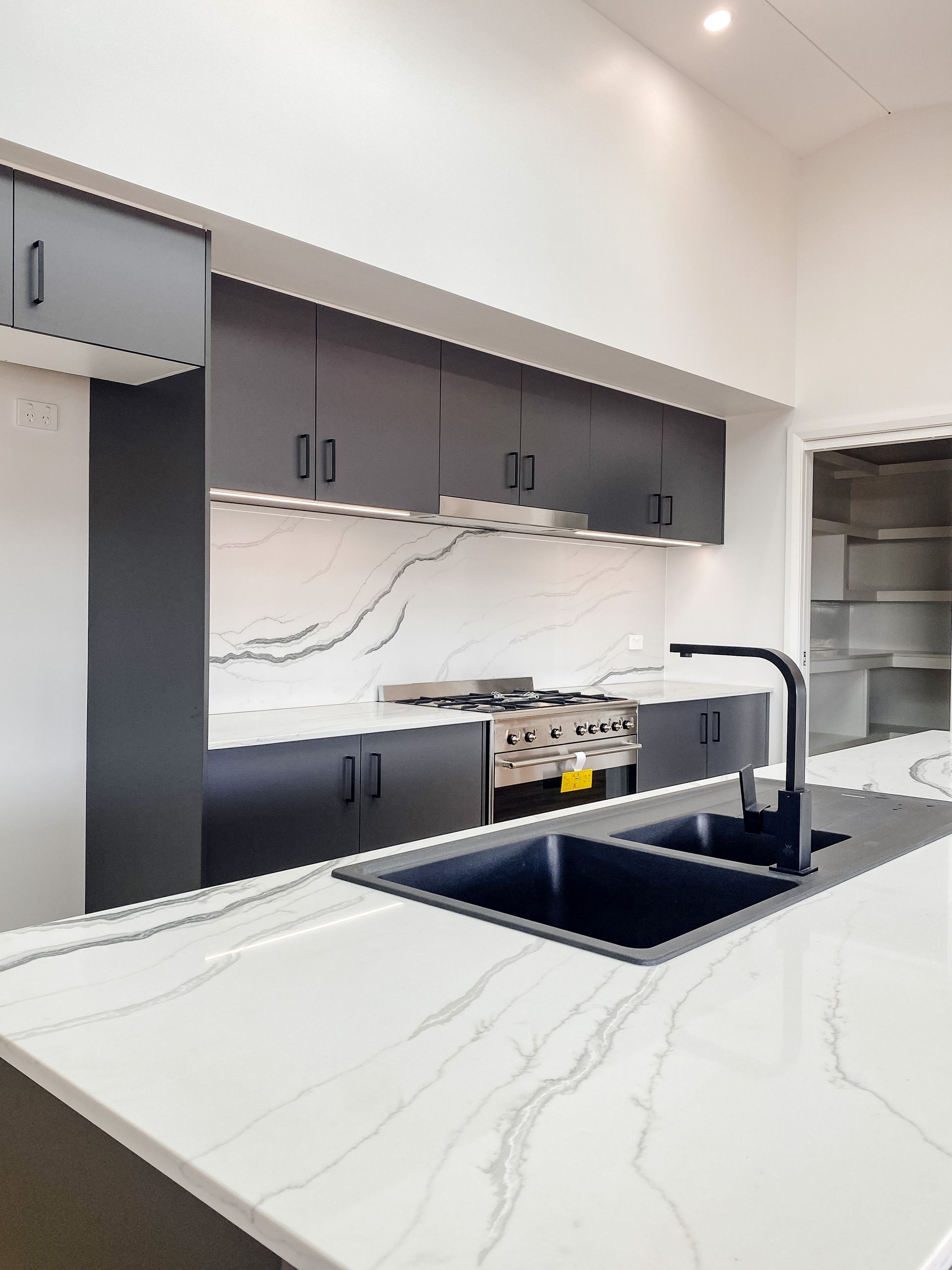 Kitchen in New Luxury Home With Granite Countertop — Kitchen Renovations in Dubbo, QLD