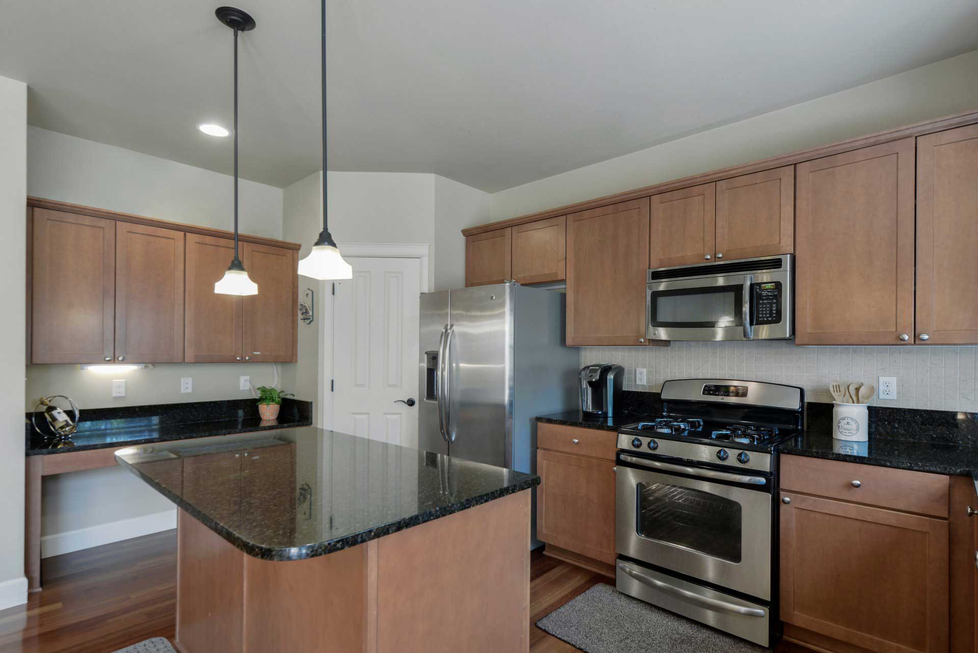 Kitchen With Brown Cabinets — Kitchen Renovations in Parkes, QLD