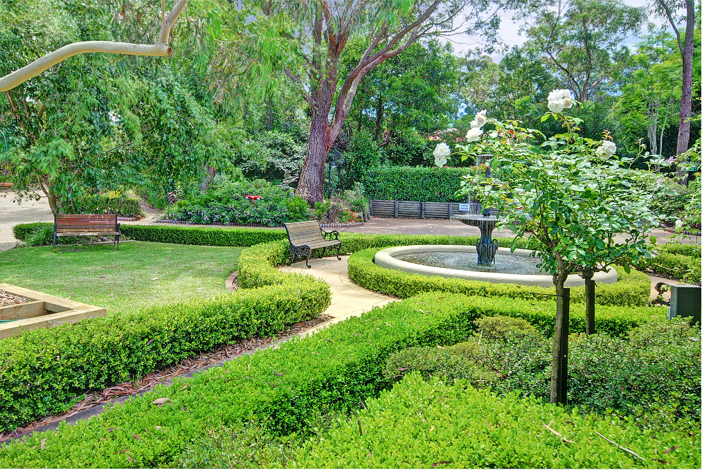 There is a fountain in the middle of the garden.