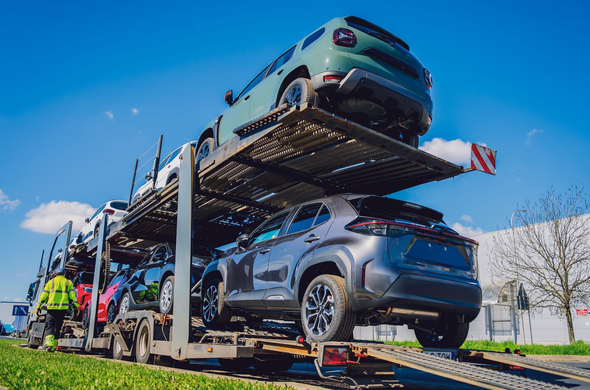 A truck is carrying a bunch of cars on a trailer.
