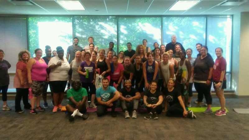 A large group of people are posing for a picture in a room.