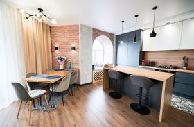 a kitchen and dining room with a table and chairs .