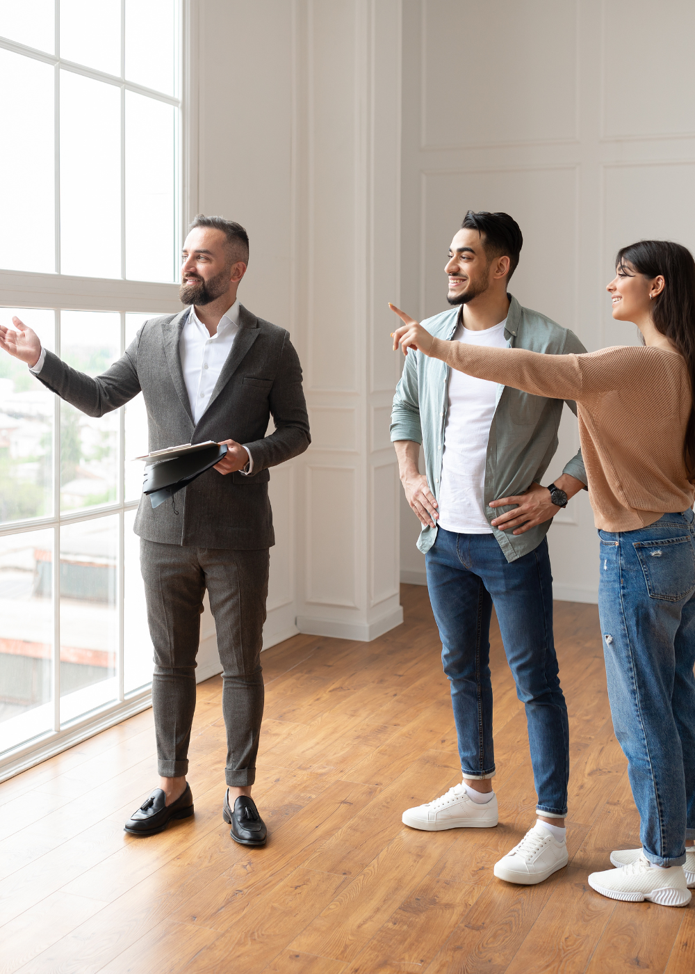 Real Estate Agent showing a property to a young couple