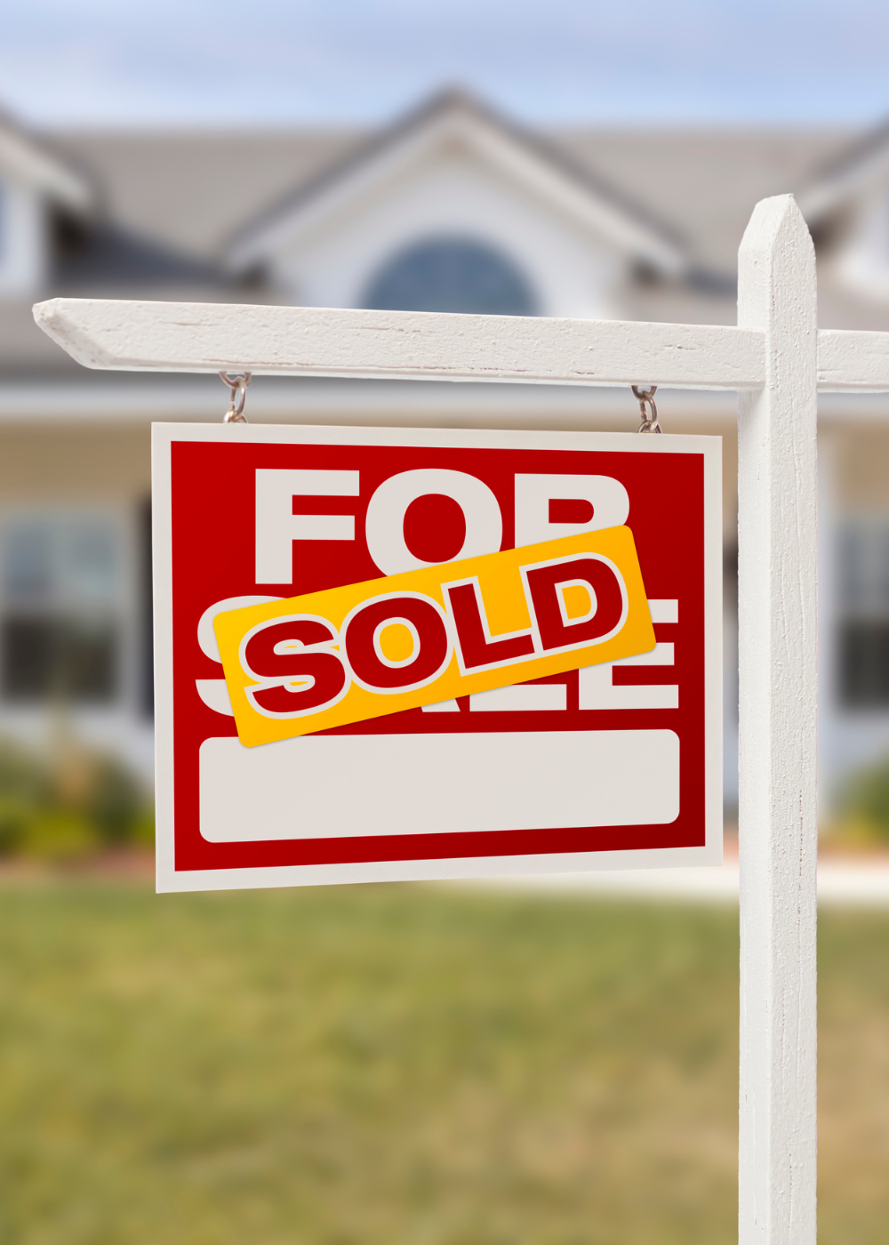 for sale sign coverd up with a 'SOLD' sticker