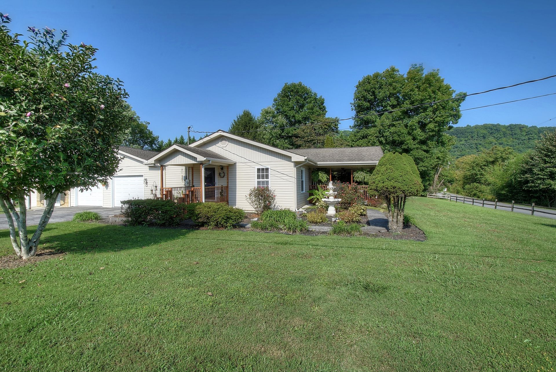 A house with a large lawn in front of it.