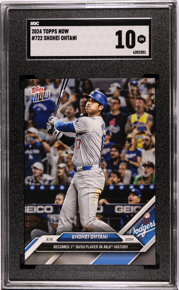 A baseball player is swinging a bat at a ball in front of a crowd.