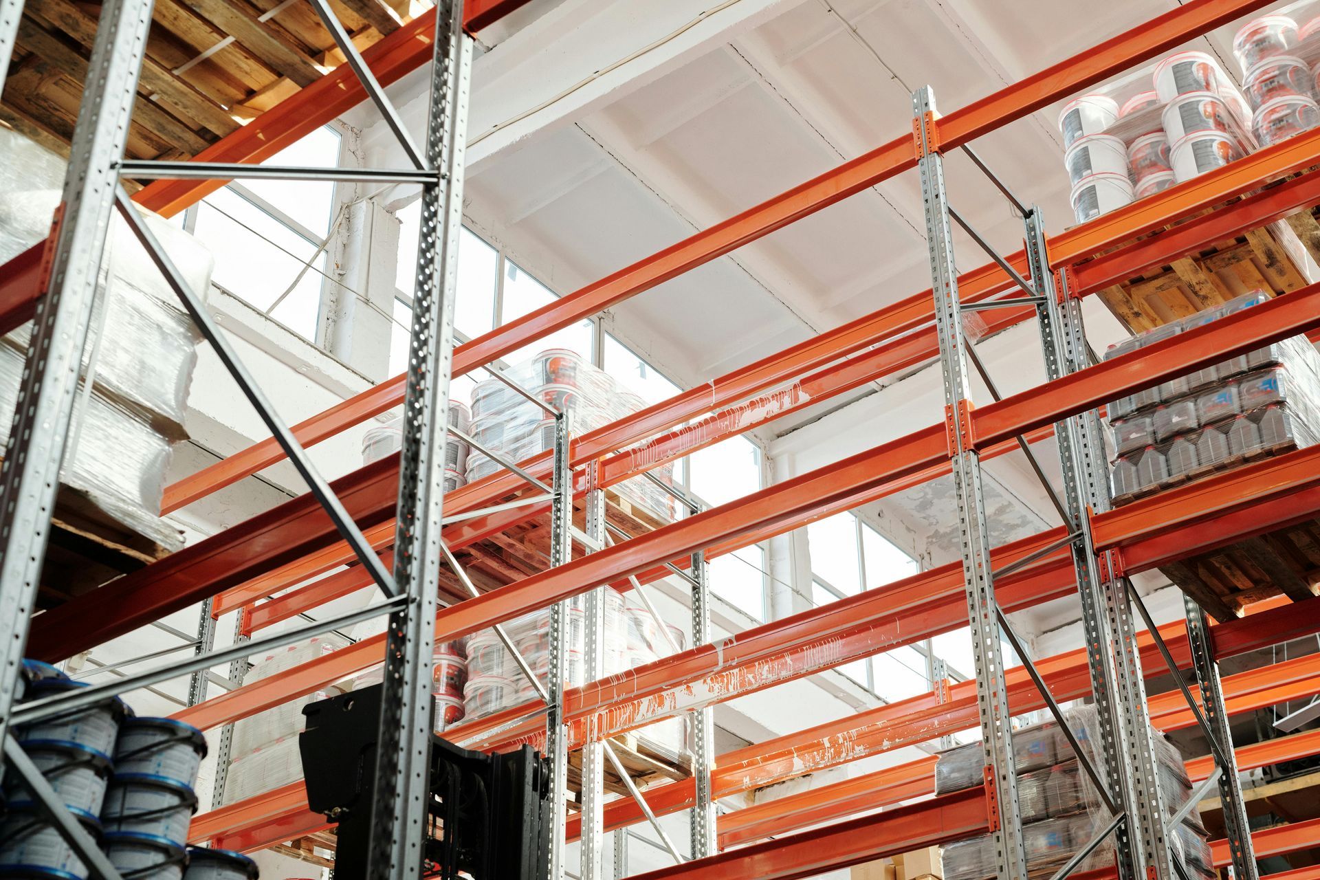 Warehouse interior with orange shelves and stacked inventory.