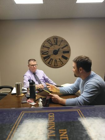Zach Baber and Brad Baber, attorneys near Fort Wayne, inside their Whitley County, Indiana office sitting around a conference room table.
