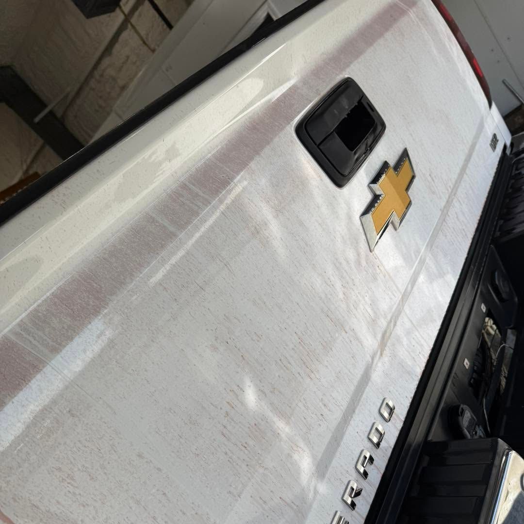 A white truck with the word silverado on the back
