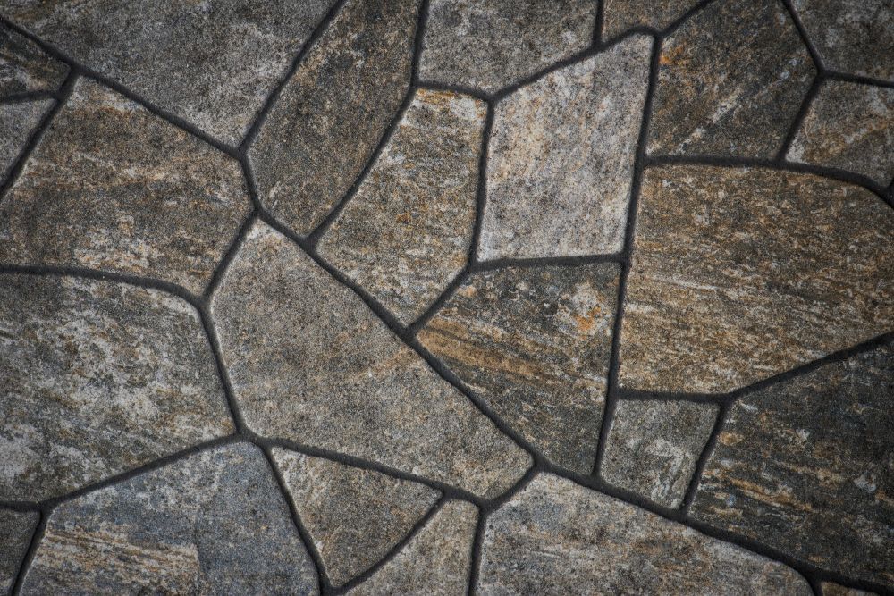 Block paving redhill with irregular shapes and dark grout lines.