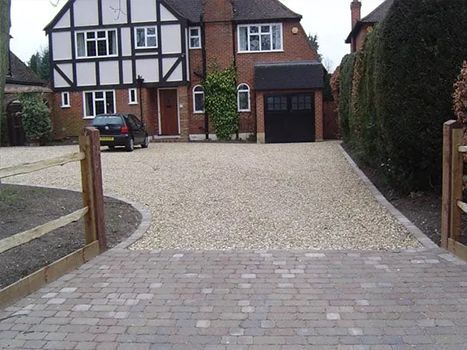 A car is parked in a driveway in front of a house