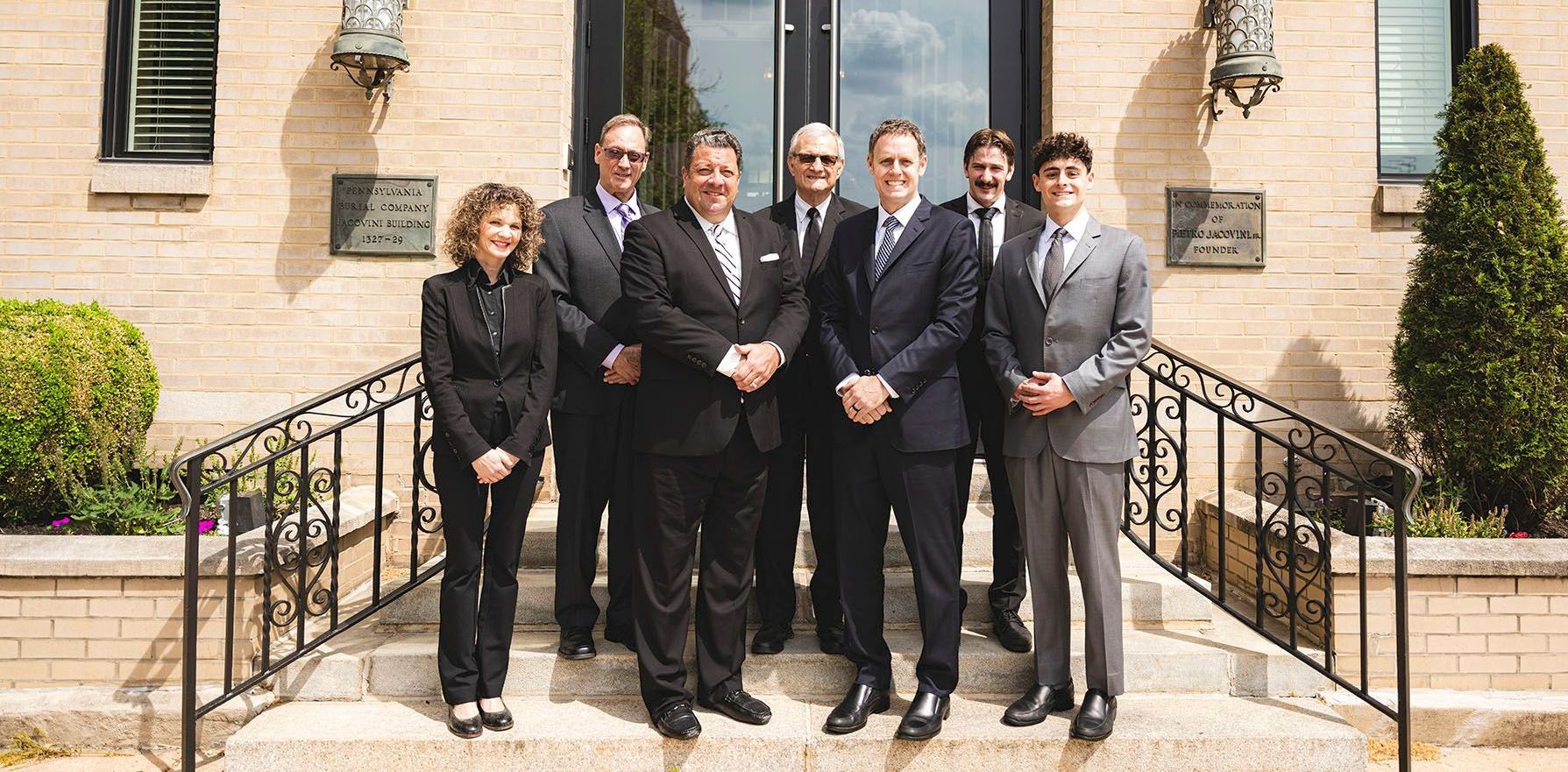 A group of people standing in front of a building