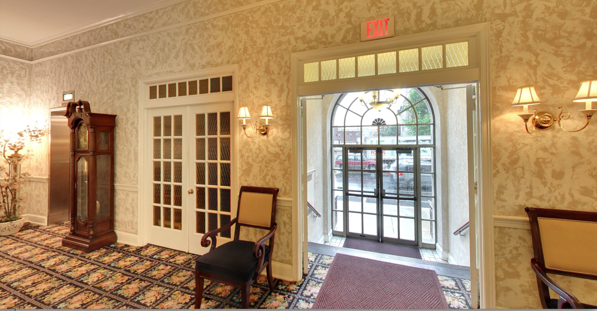A room with a red exit sign on the wall