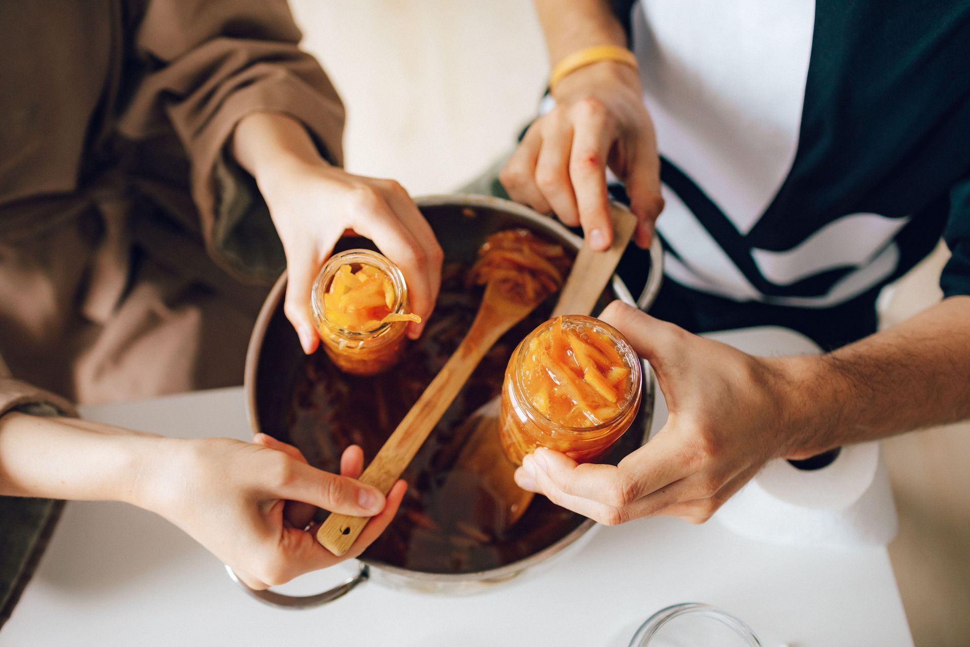 People Canning Fruit at Home