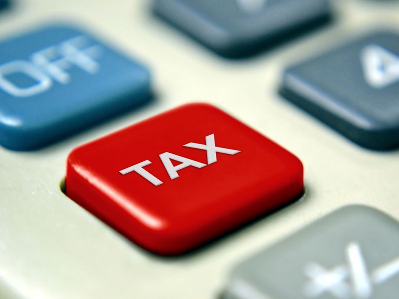 A close up of a red tax button on a calculator