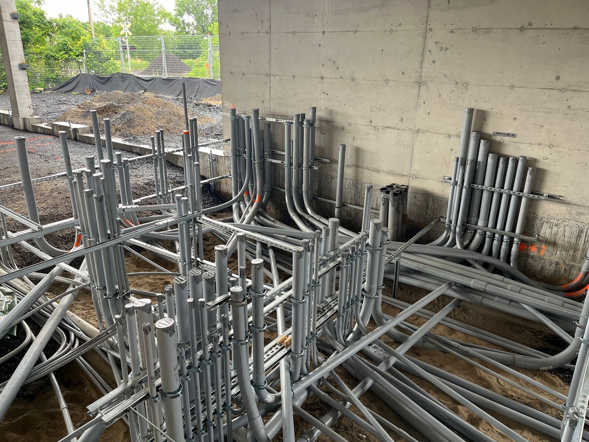A bunch of metal pipes are stacked on top of each other in a room.