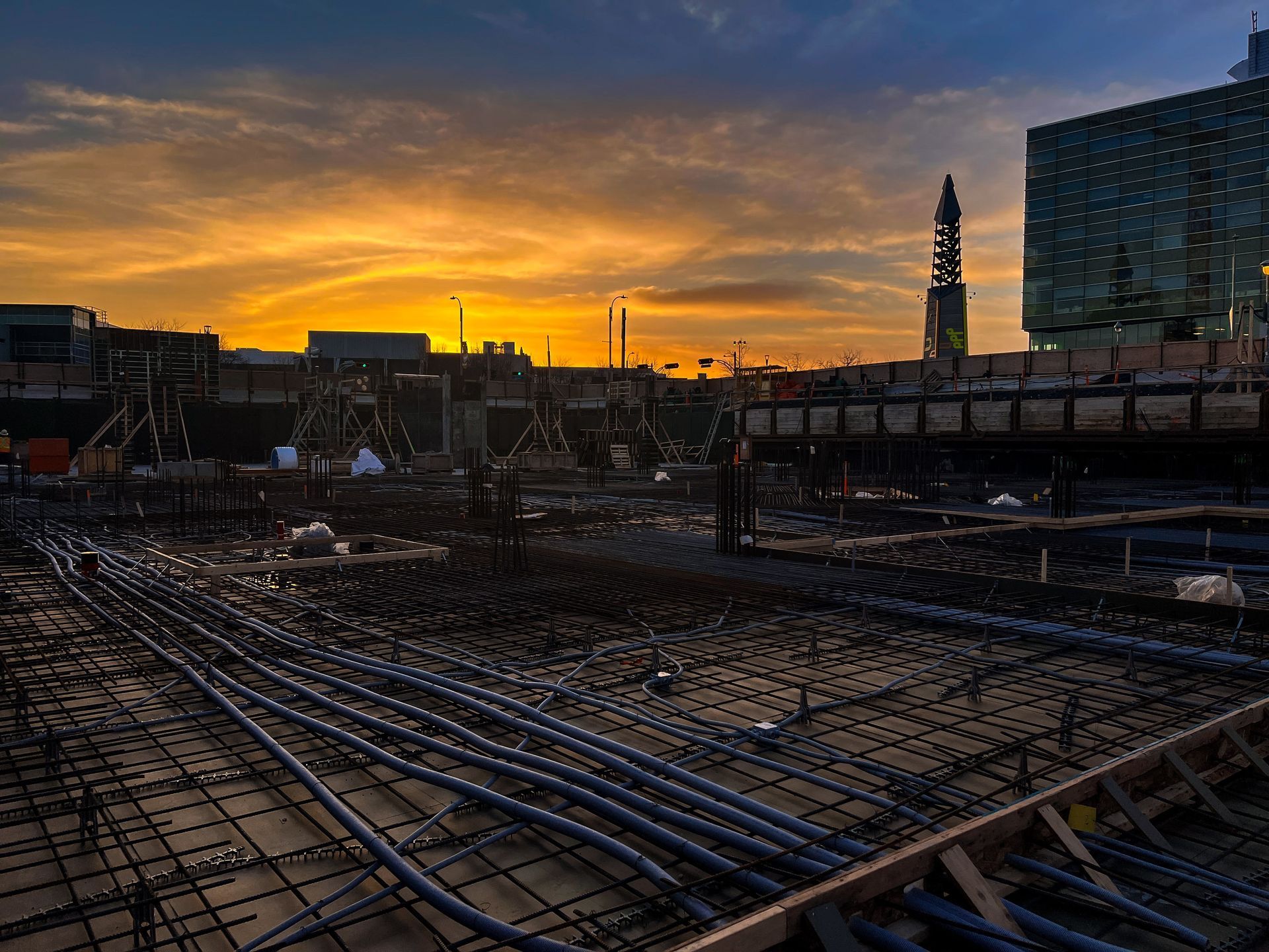 A construction site with a sunset in the background