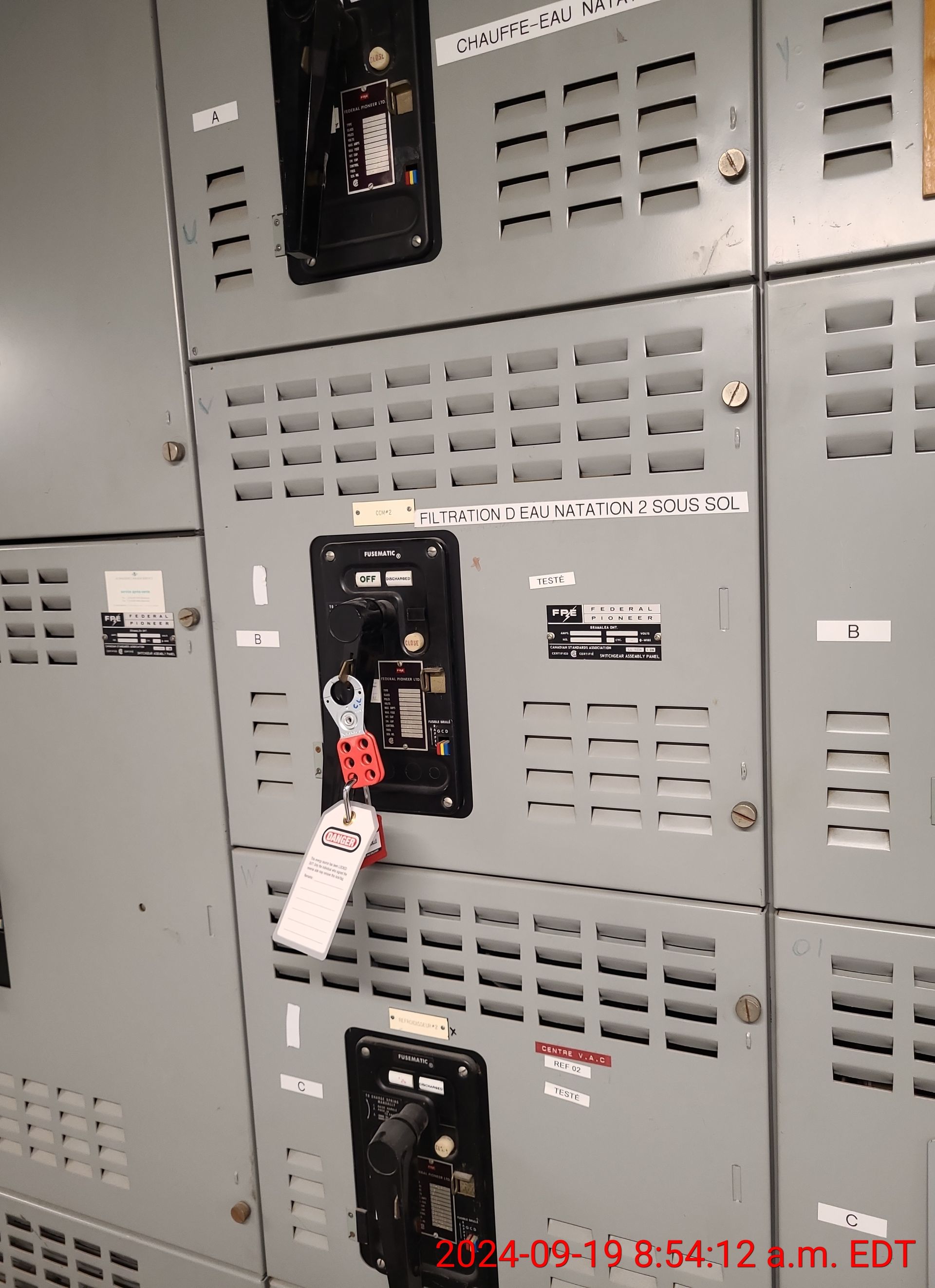 A bunch of lockers are lined up on a wall.
