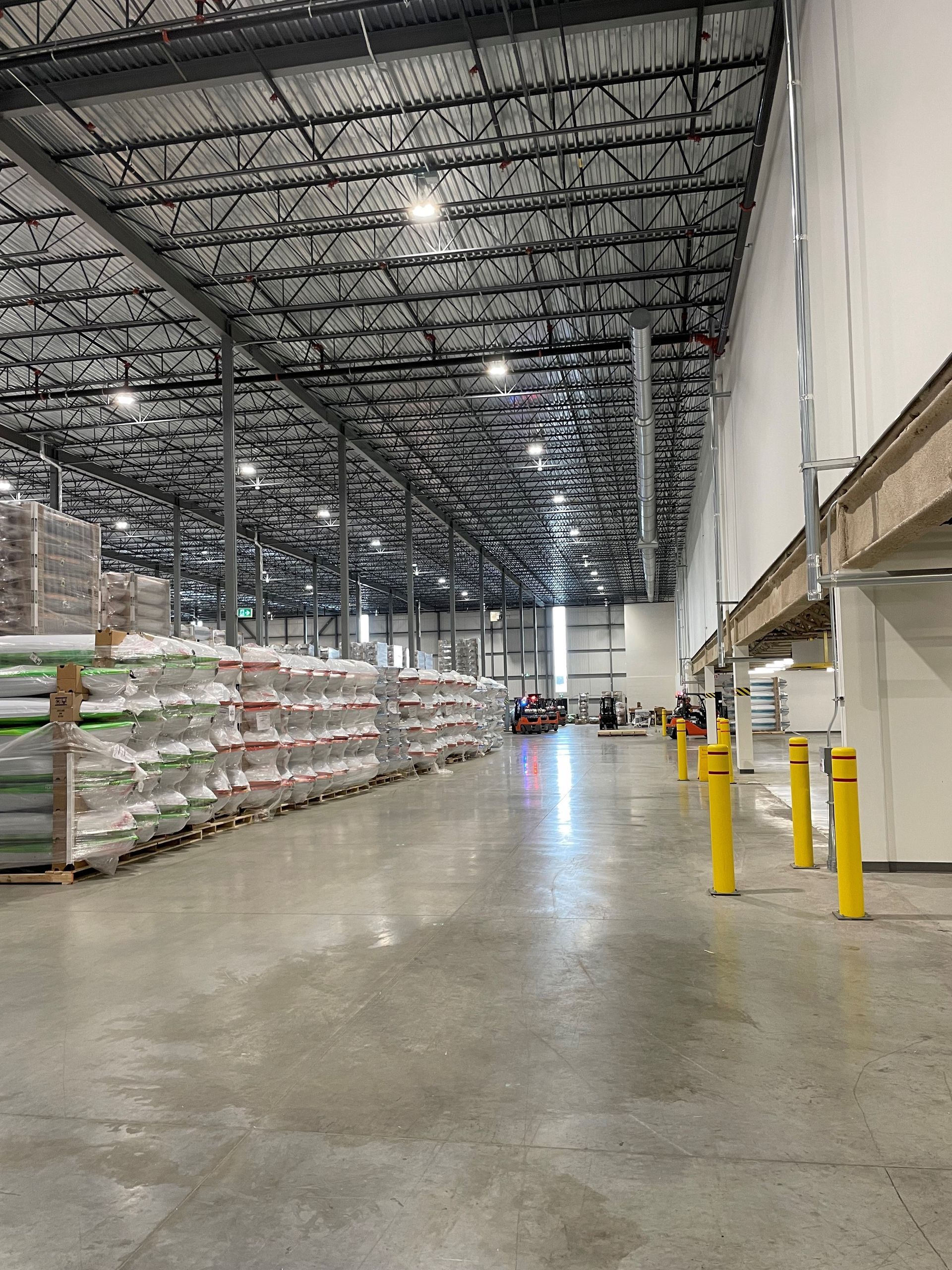 A large warehouse filled with lots of bags and poles.