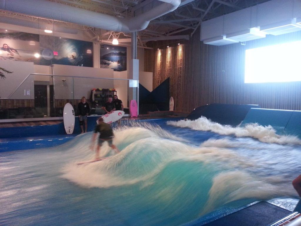 A man is riding a wave on a surfboard
