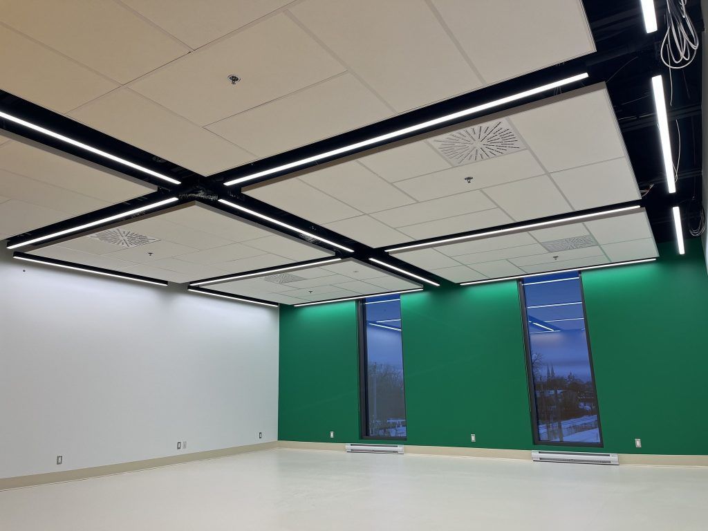 An empty room with green walls and white ceilings