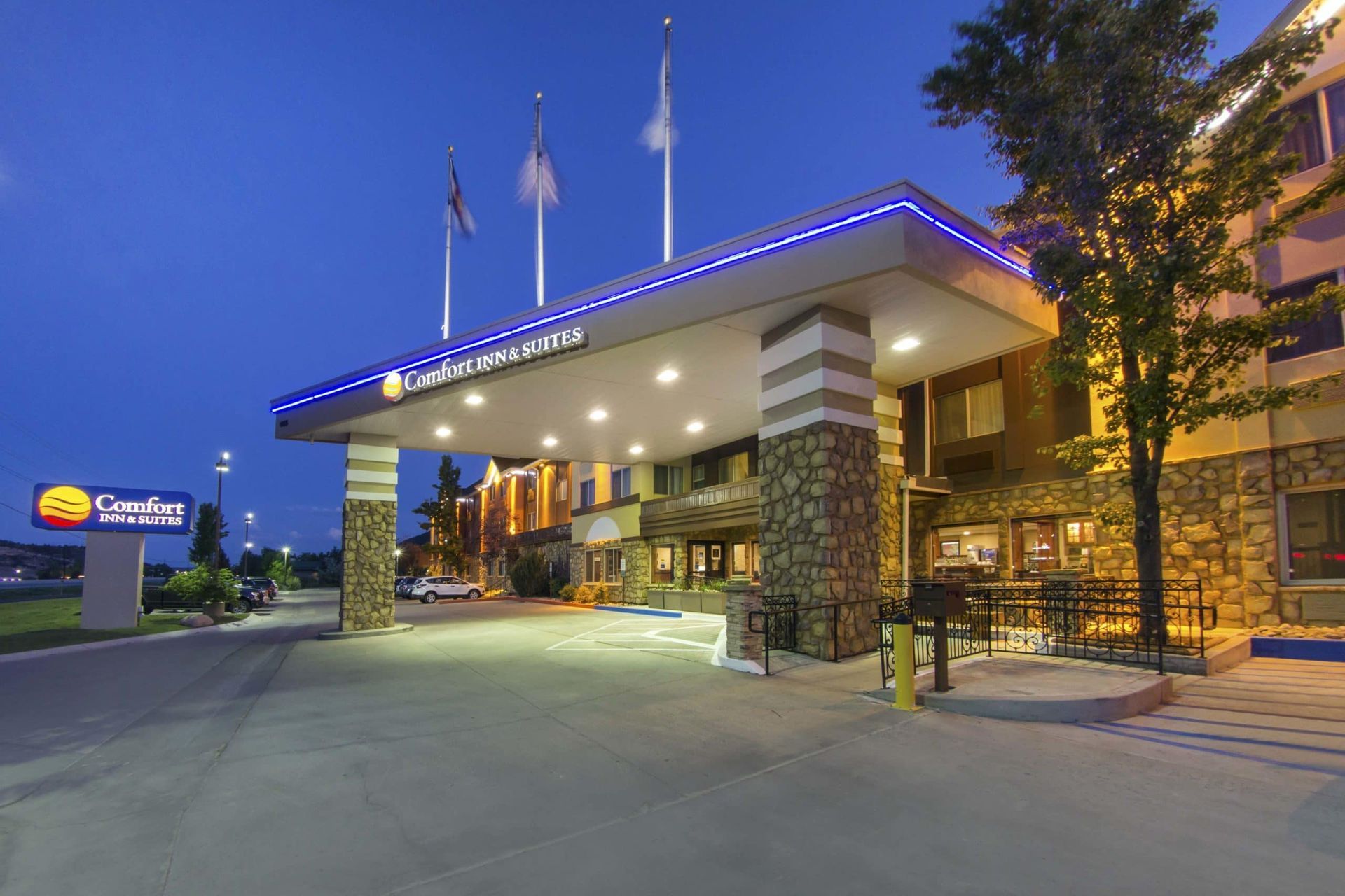 The entrance to a hotel is lit up at night.