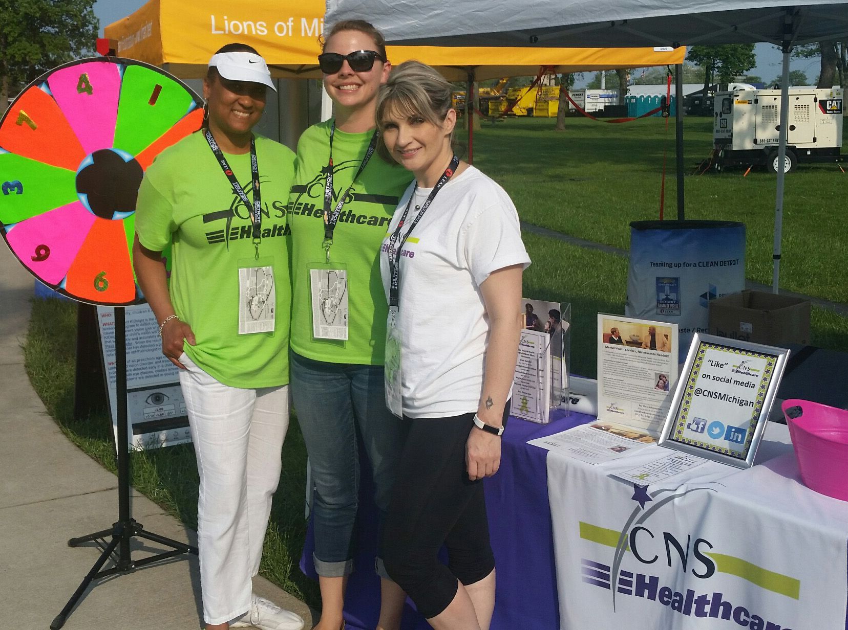 Three women standing in front of a table that says cns healthcare