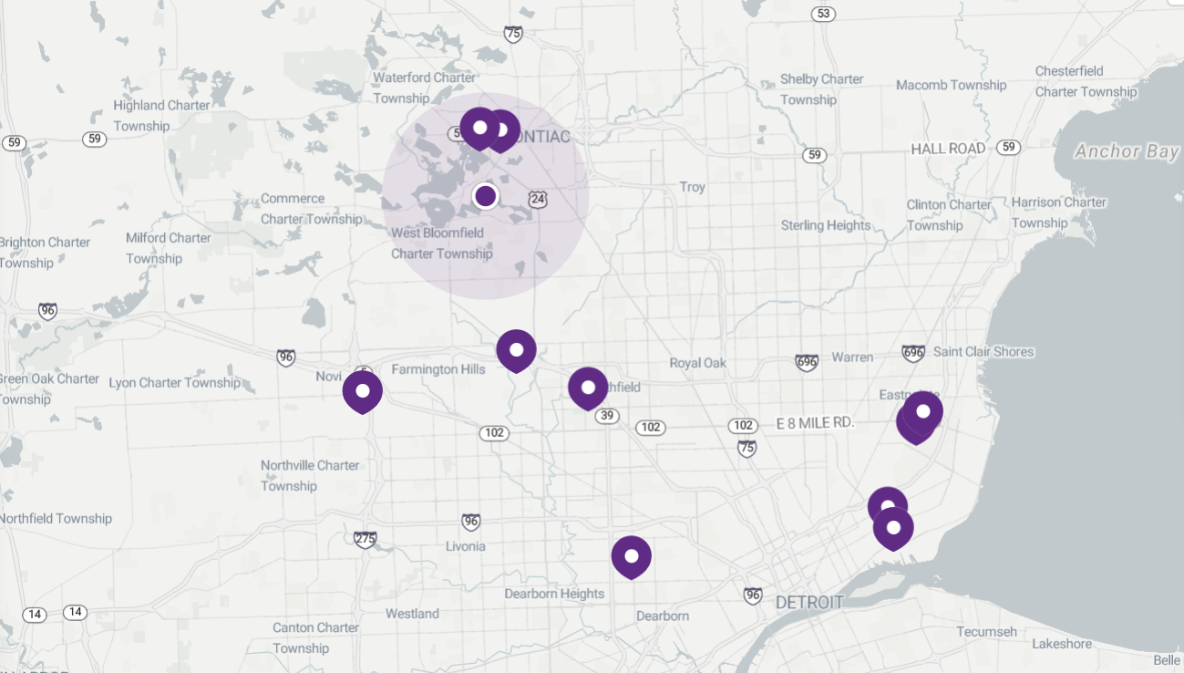 Map with purple markers indicating locations, some within a shaded circle.