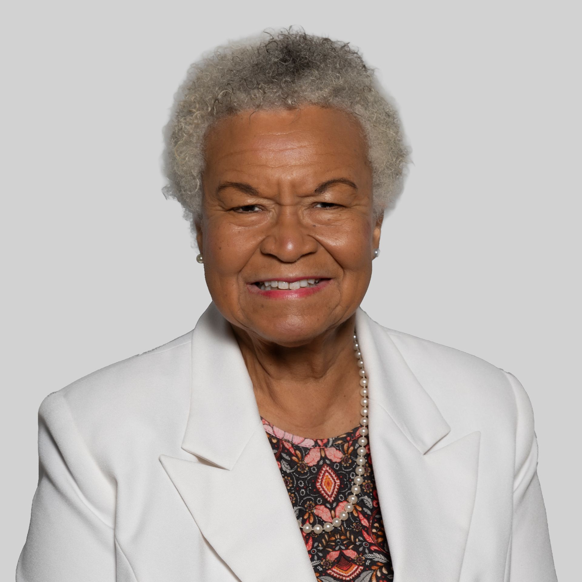 A woman wearing glasses is smiling for the camera