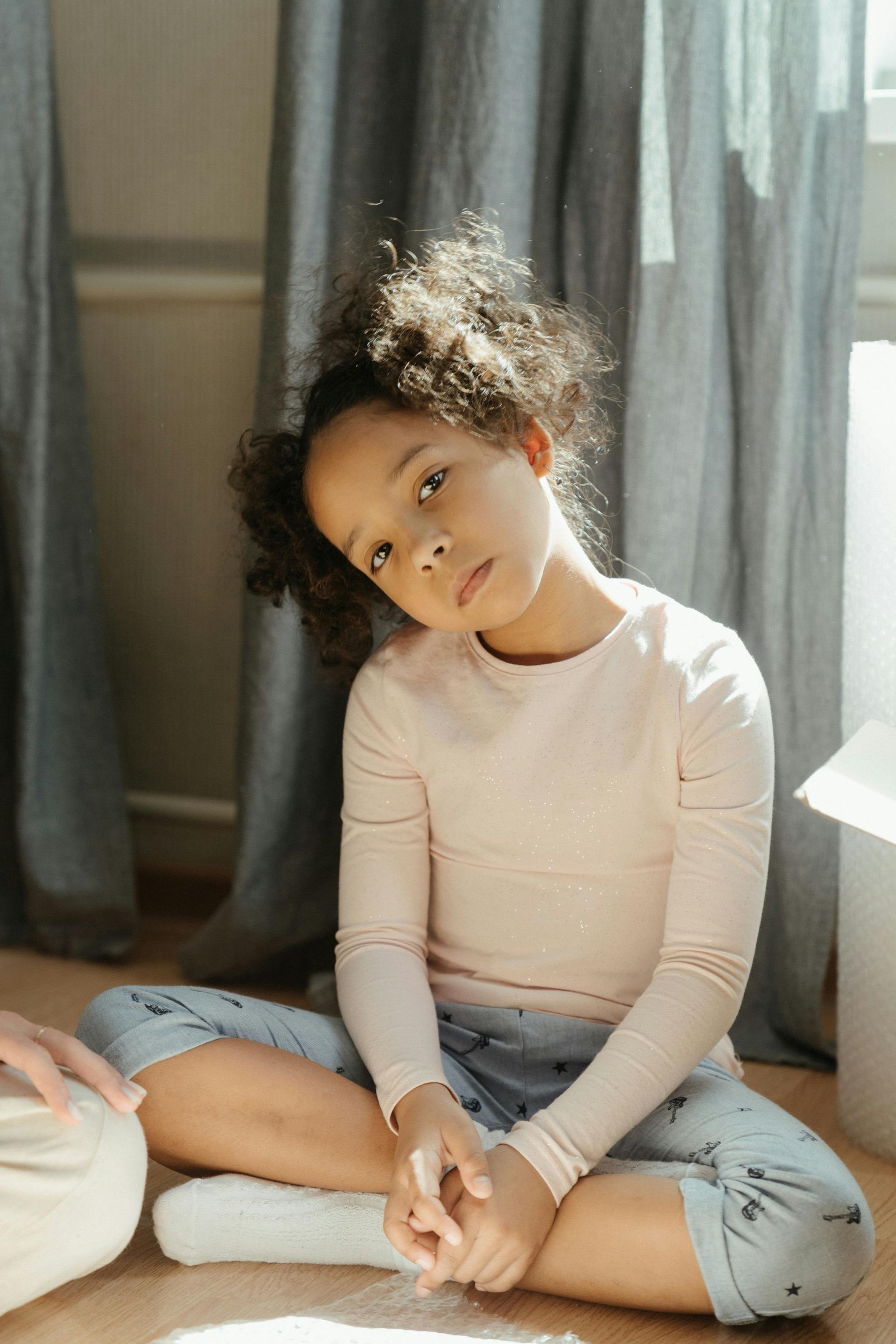 A child sits on the floor.