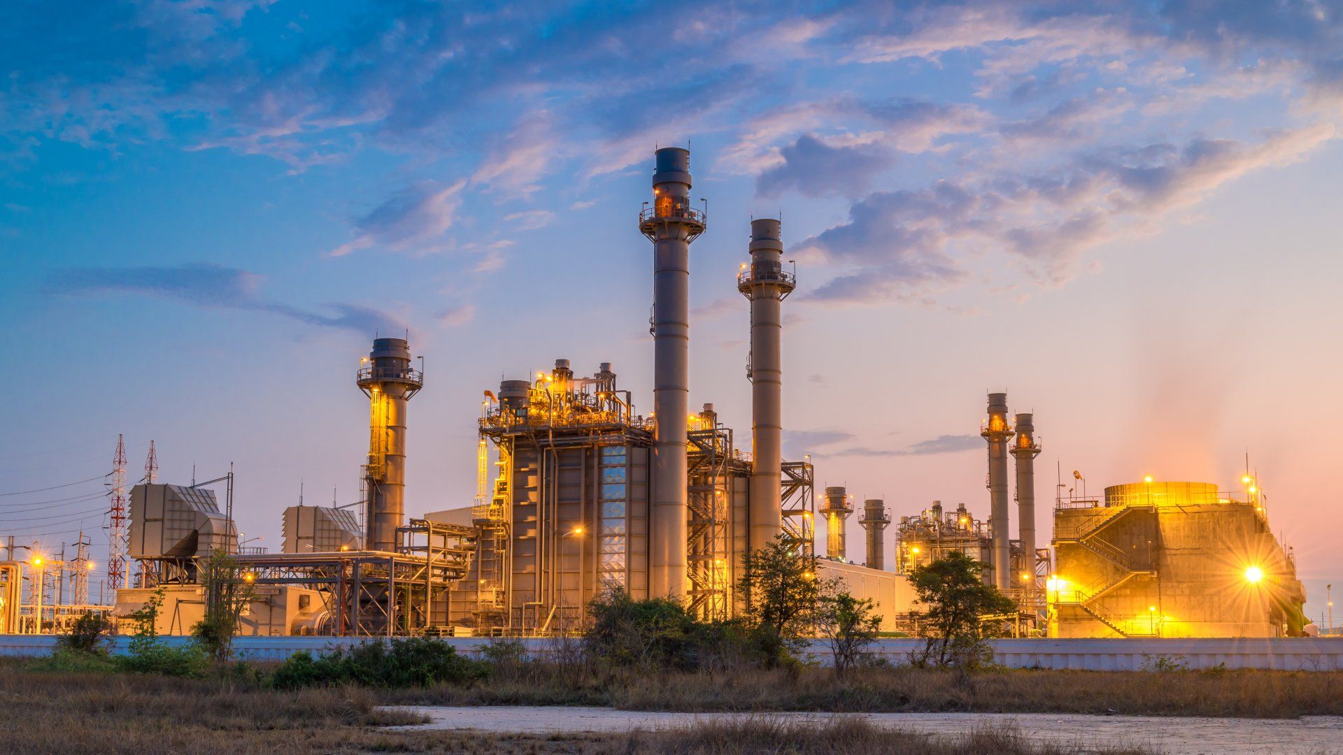 A large oil refinery is lit up at night.