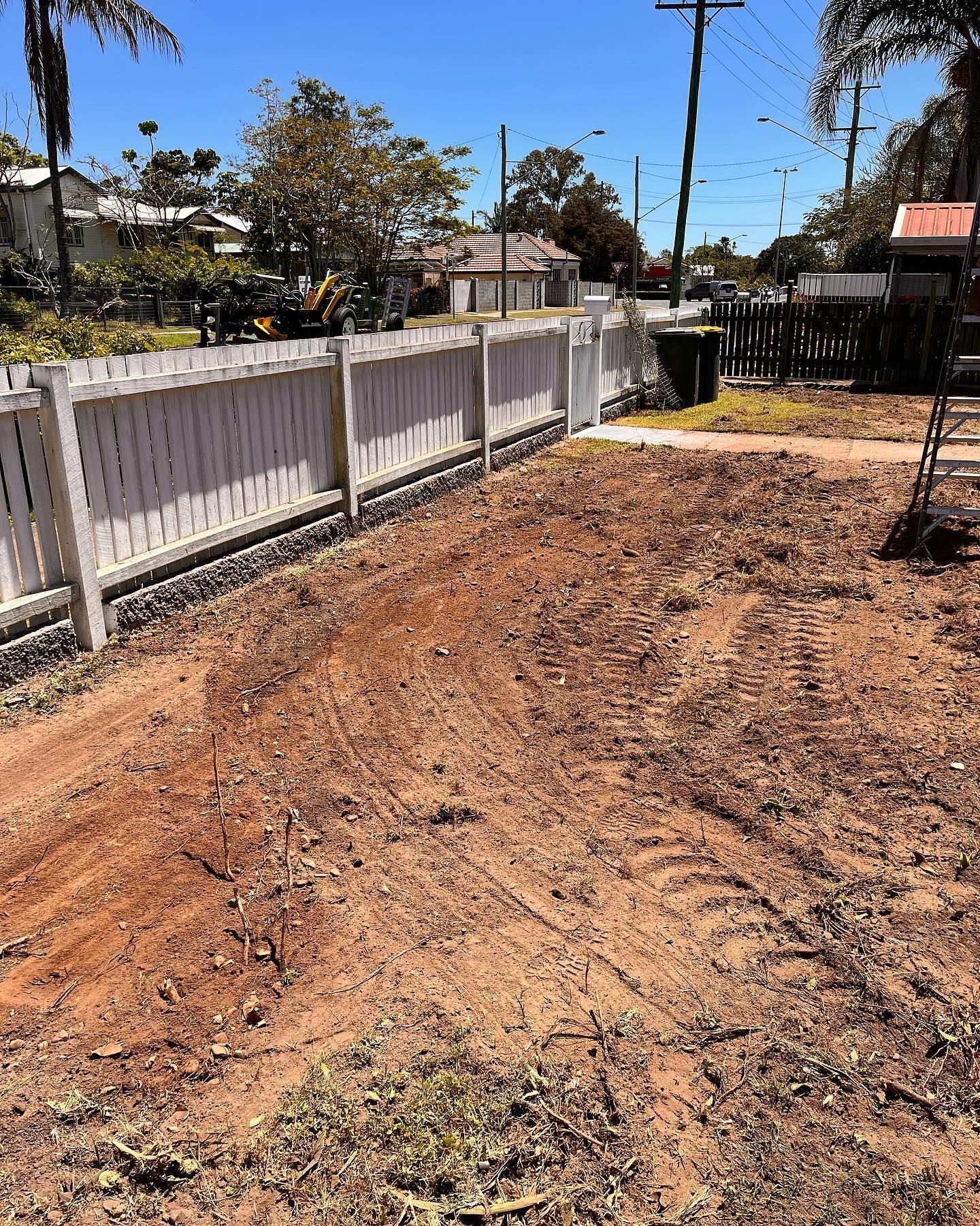 Dirt Lot Next to a White Picket Fence and Street — All Access Mini Earthworks in Innes Park, QLD