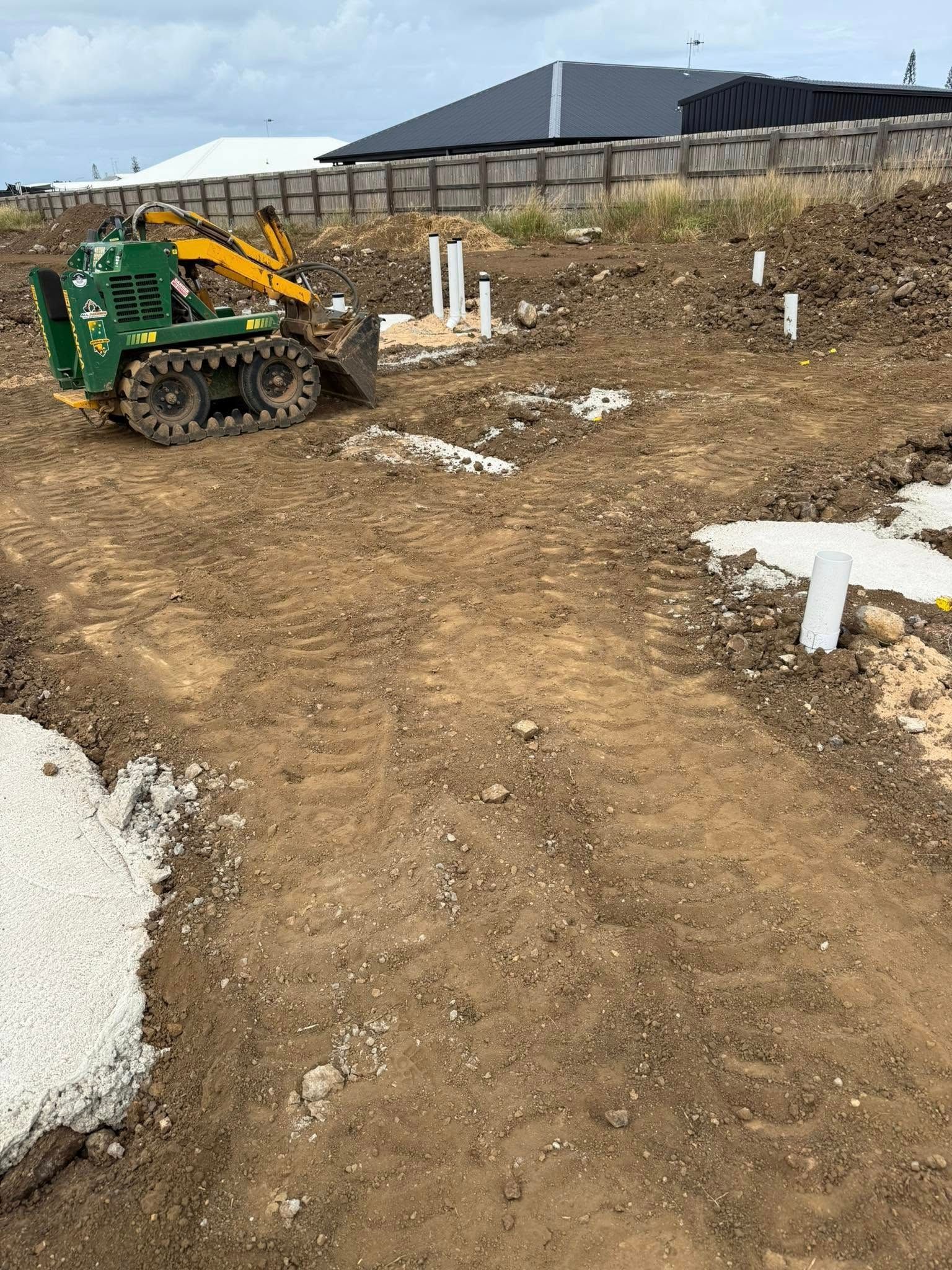 A Green Skid Steer Works on a Dirt Construction Site — All Access Mini Earthworks in Gin Gin, QLD