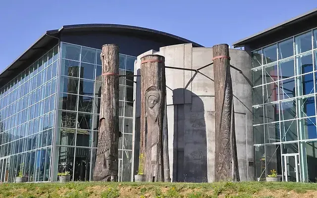 A building with a lot of windows and a sculpture in front of it