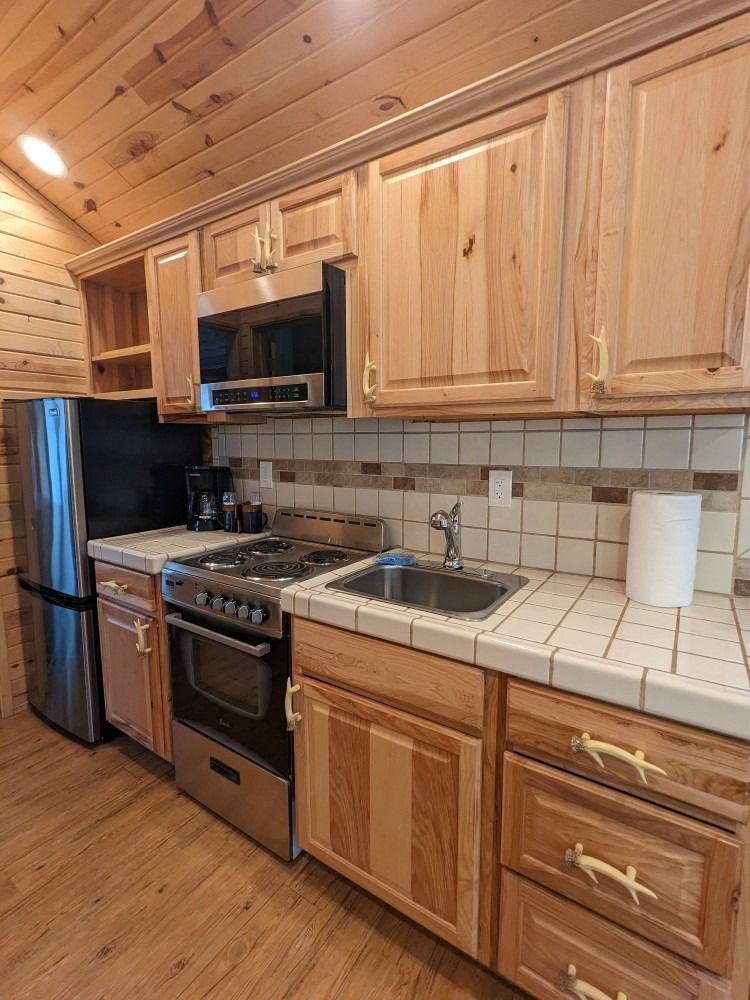 A kitchen with wooden cabinets and stainless steel appliances