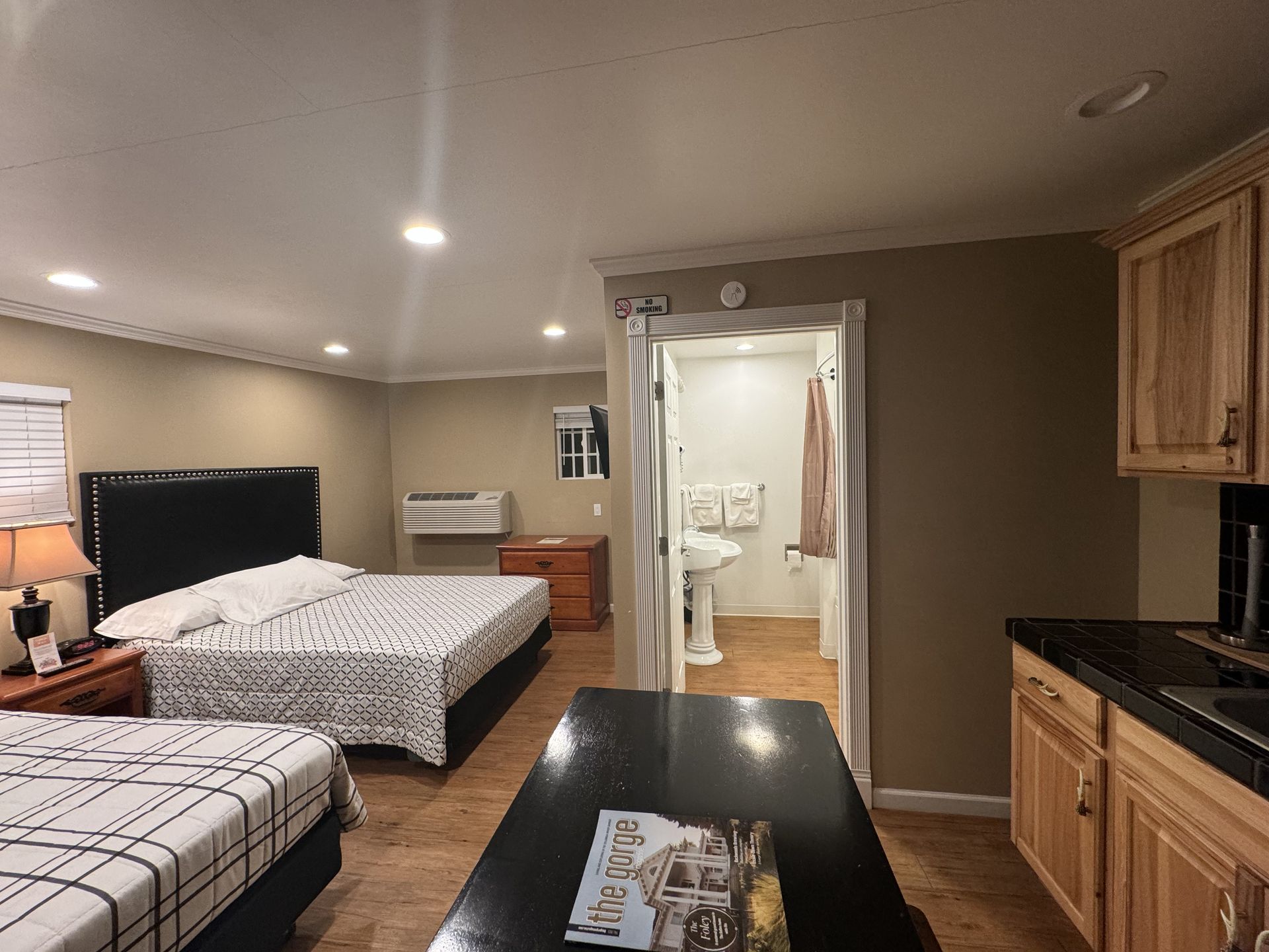 A hotel room with two beds and a table