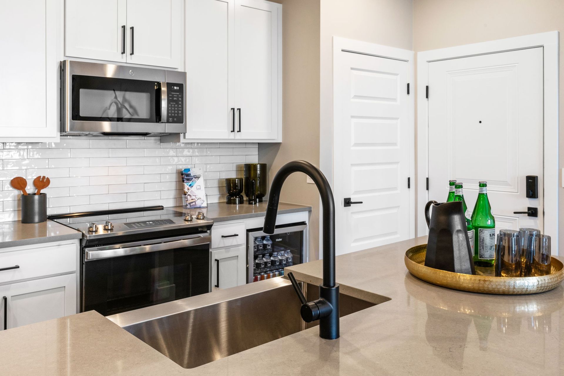 Northwest Crossing apartment kitchen with appliances, white cabinets, island and sink,