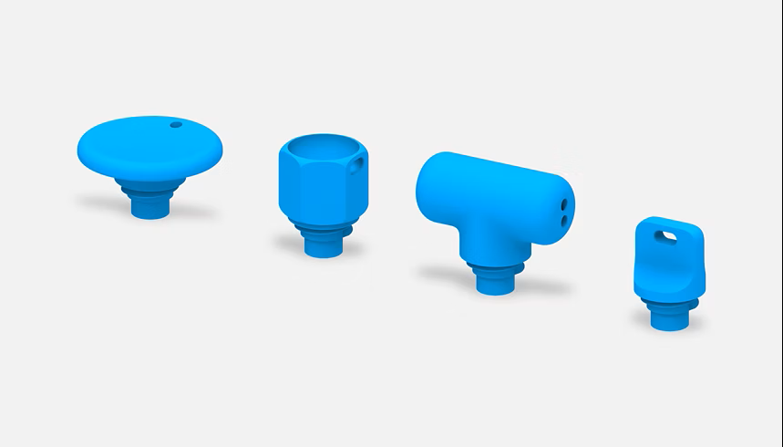 A collection of pen tops, one a t-top, one a disk, one a hexagon, and one flat