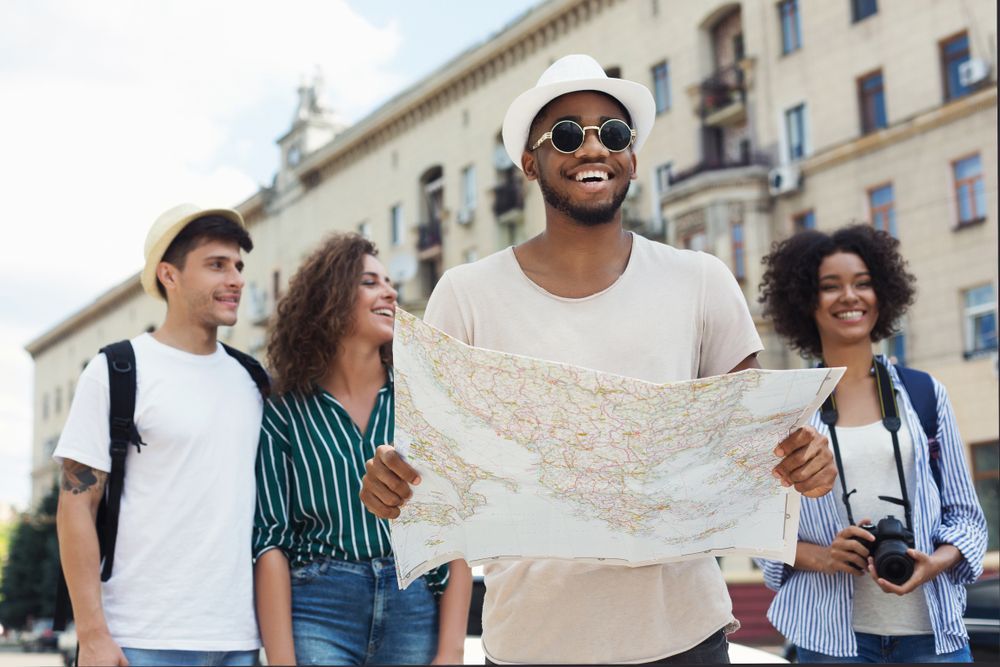 A man is holding a map in front of a group of people.