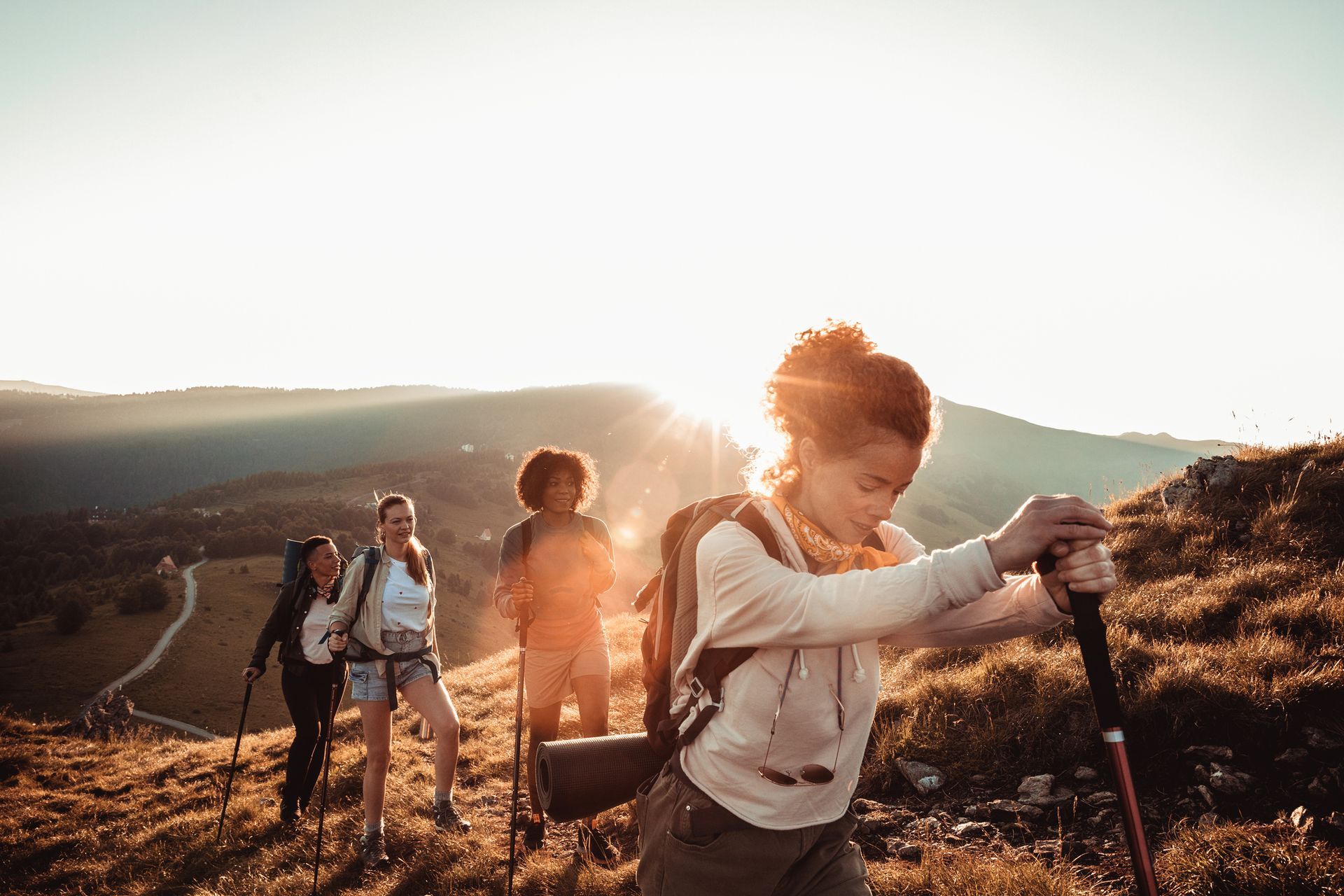 A group of people are hiking up a hill.