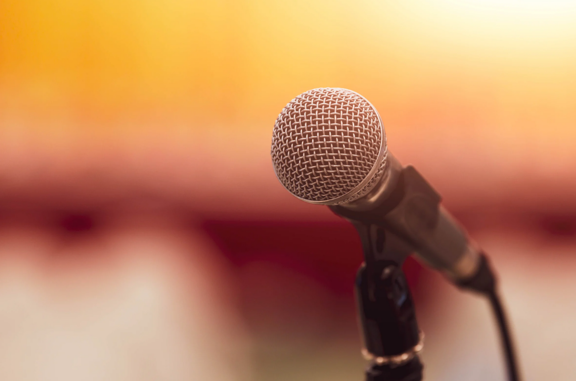 A close up of a microphone on a stand on a stage.