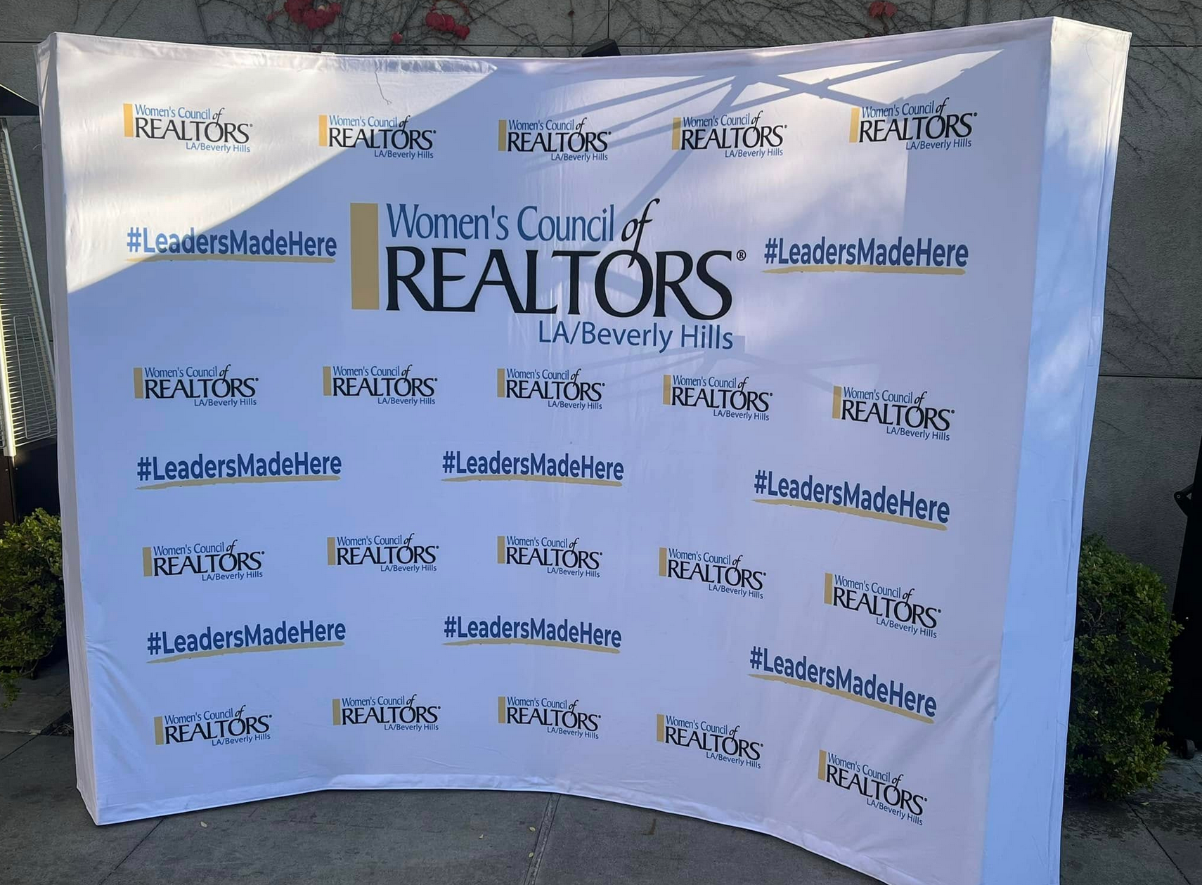 White backdrop for the Women's Council of REALTORS, LA/Beverly Hills, with logo and 